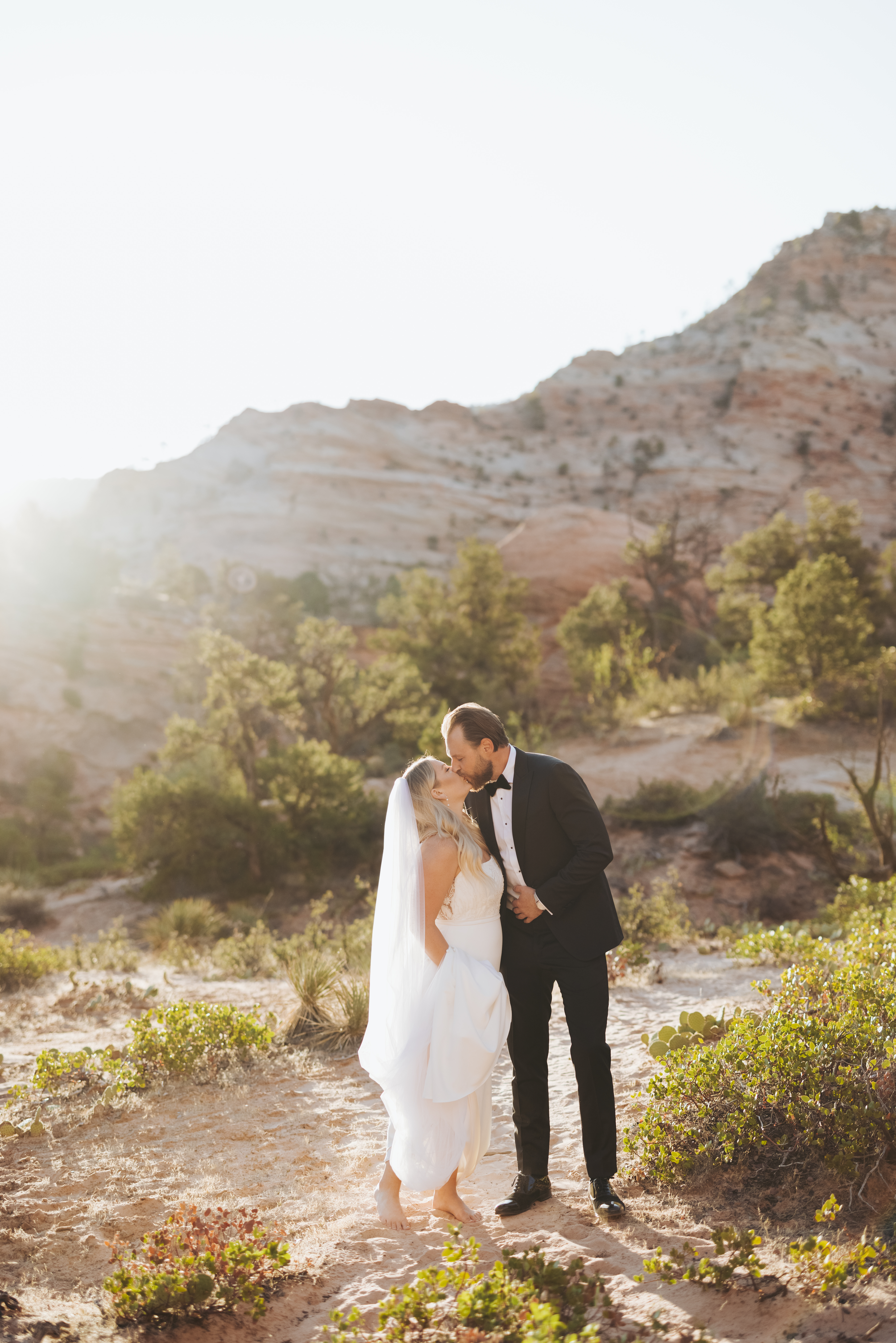bride and groom kissing in zion national park