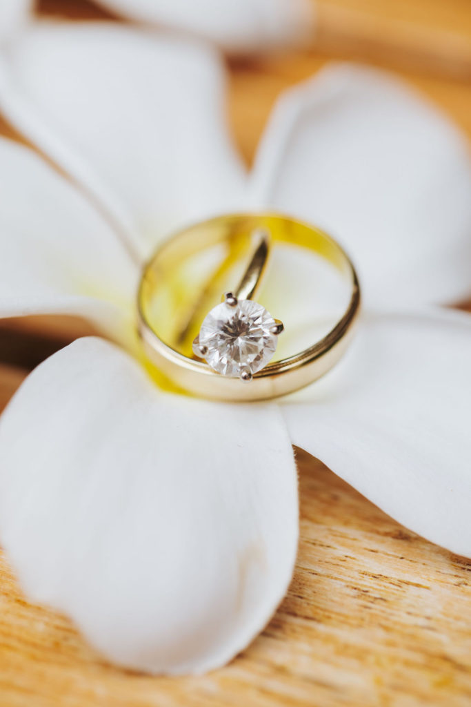 maui wedding rings on flower
