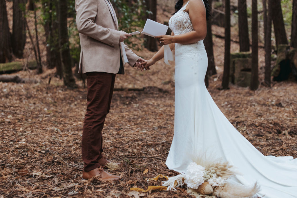 bride and groom exchanging vows in redwood forest