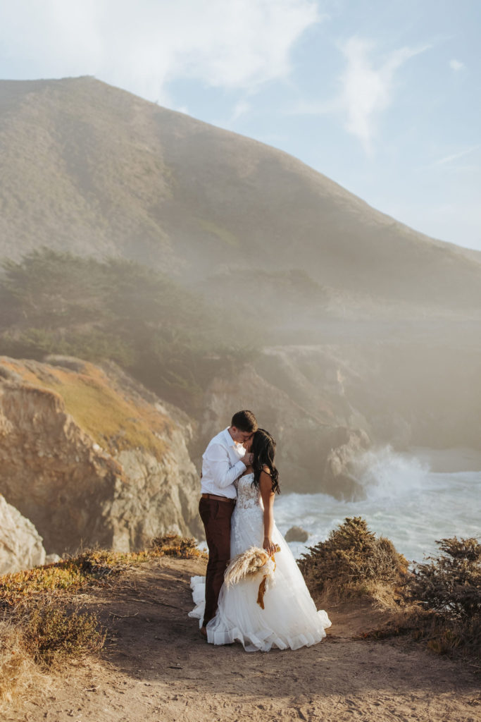 bride and groom portraits on rocky coast in big sur