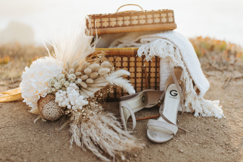 big sur elopement picnic with guess bridal shoes and bouquet