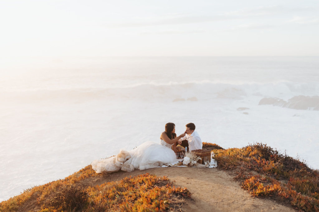 bride and groom eating chocolate strawberries in big sur elopement picnic