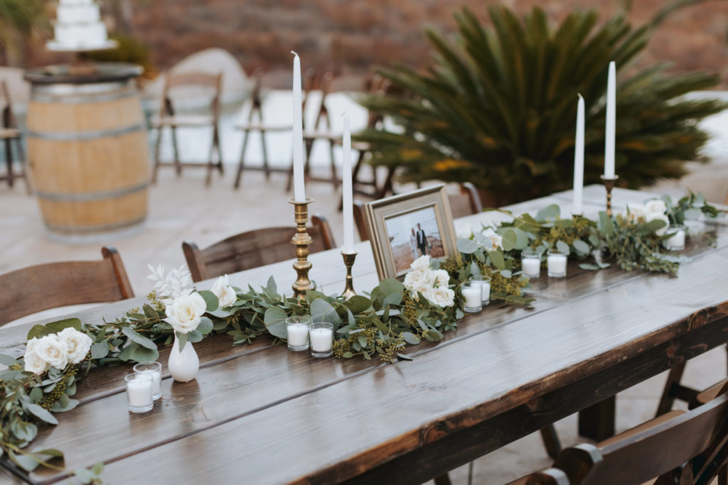 candles and greenery on reception tables at temecula wedding