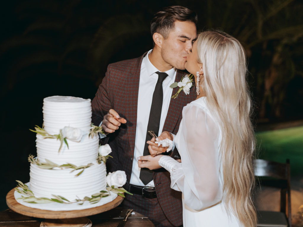 bride and groom cutting cake at temecula wedding reception