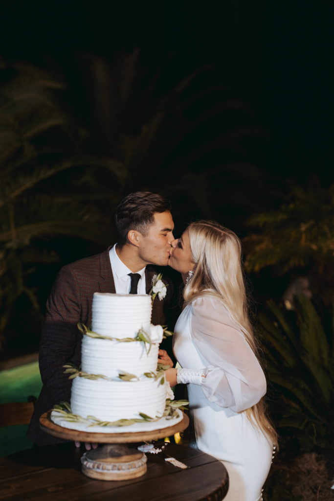 bride and groom cutting cake at temecula wedding reception