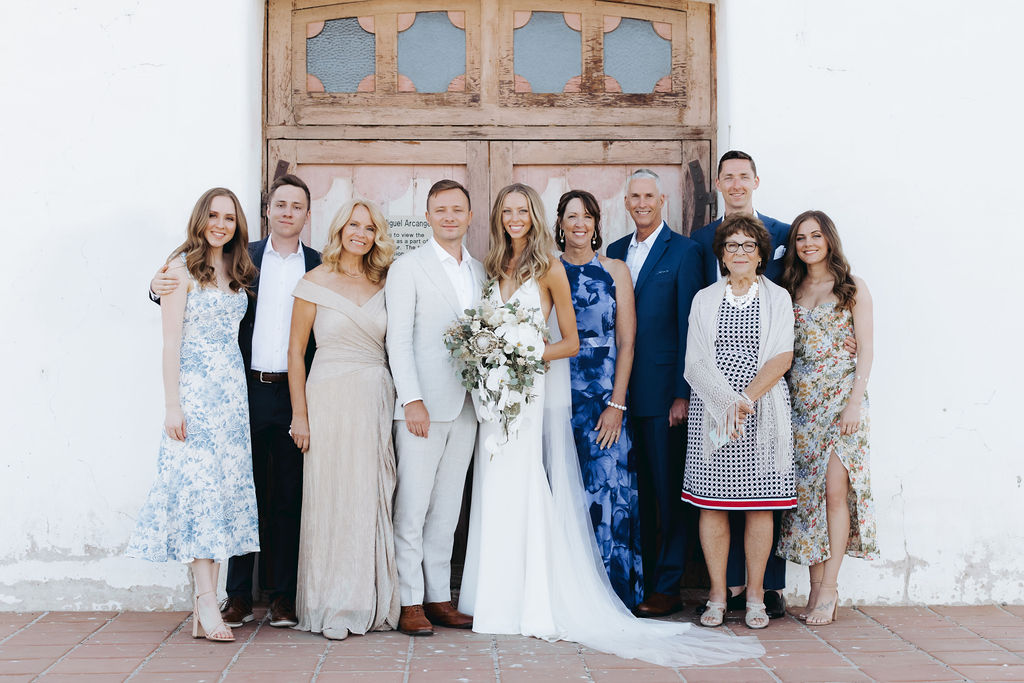 bride and groom with family at mission san miguel ceremony