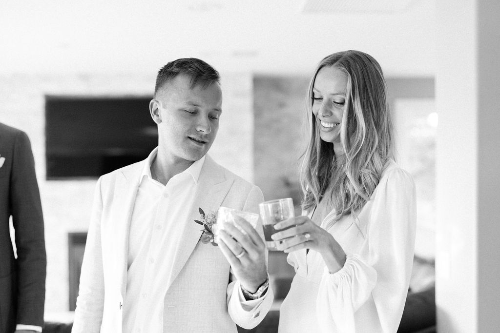 bride and groom drinking cocktails