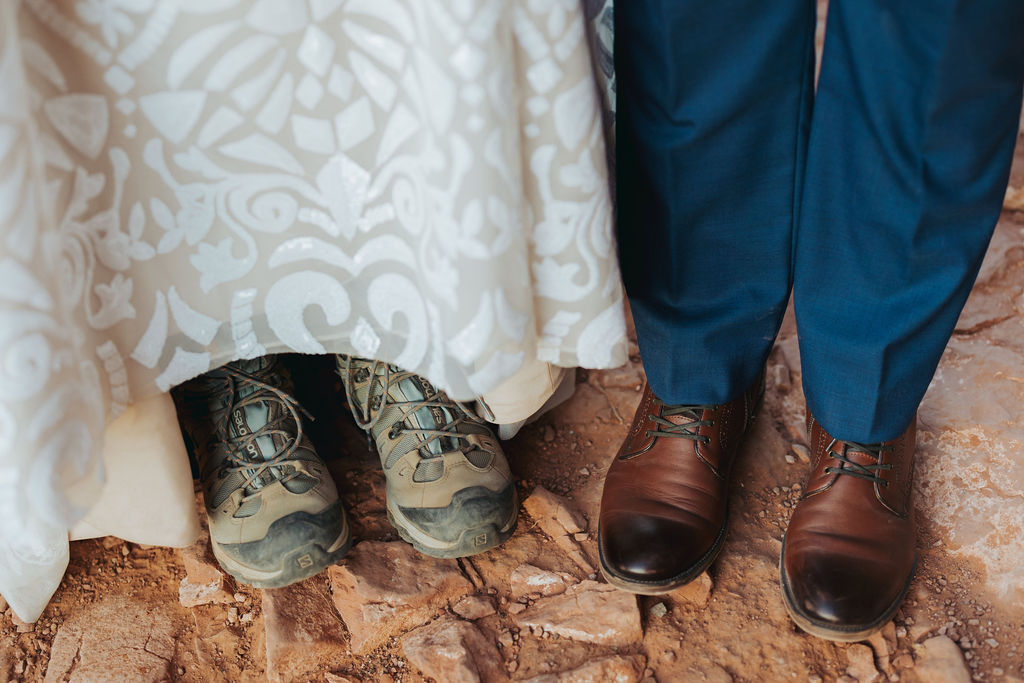 bride wearing hiking boots with groom in cathedral rock arizona