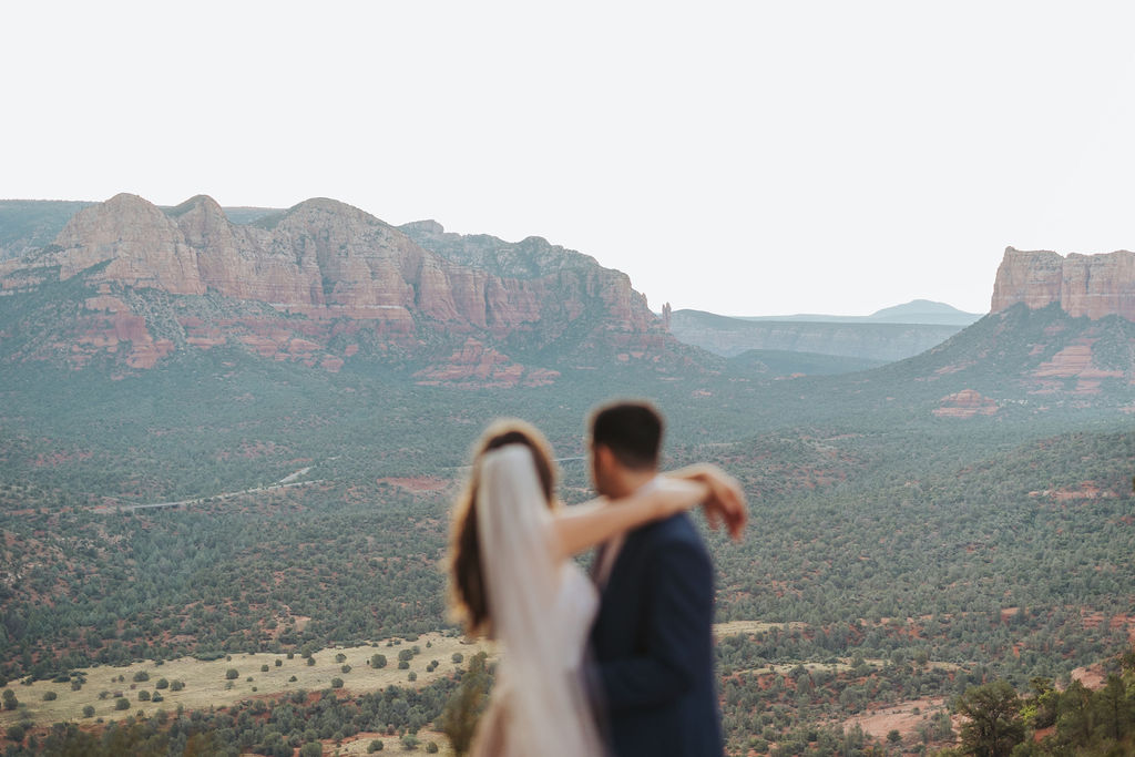 bride and groom looking over sedona arizona