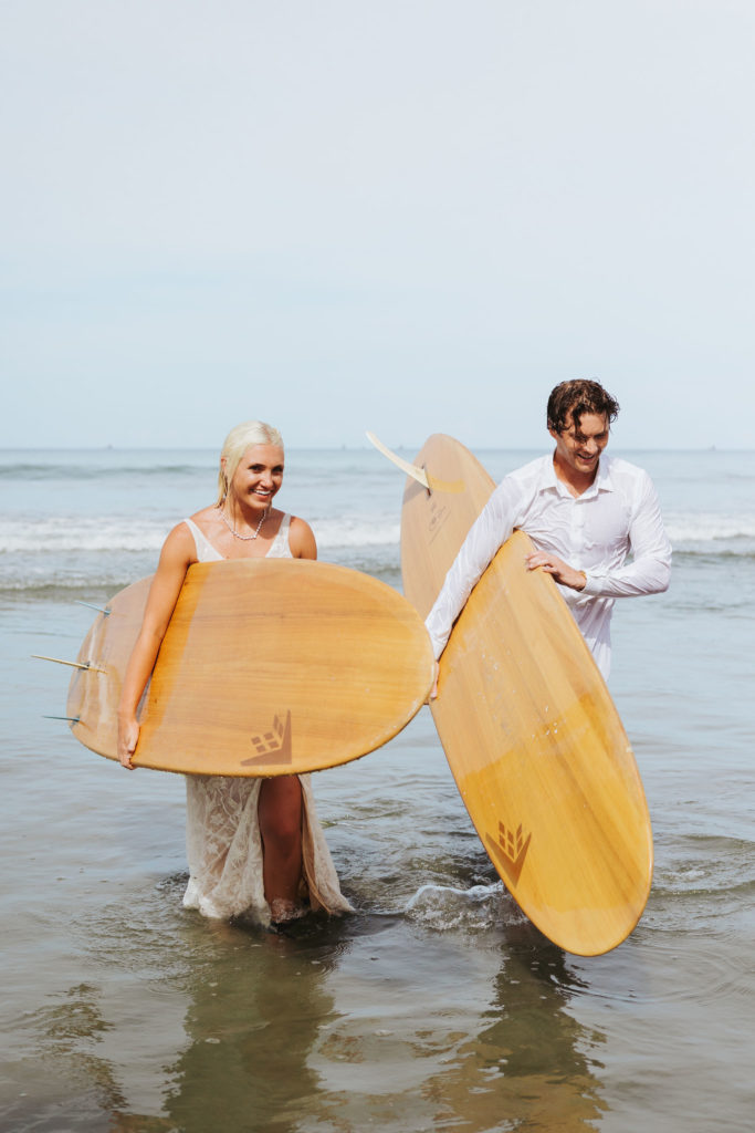 bride and groom in wedding attire after surfing in costa rica