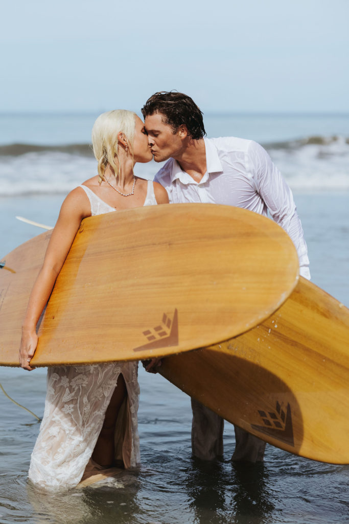 bride and groom in wedding attire after surfing in costa rica