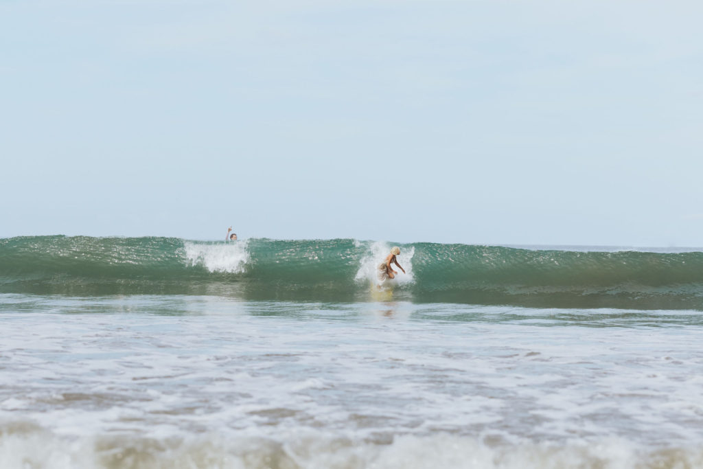 bride and groom surfing in costa rica elopement
