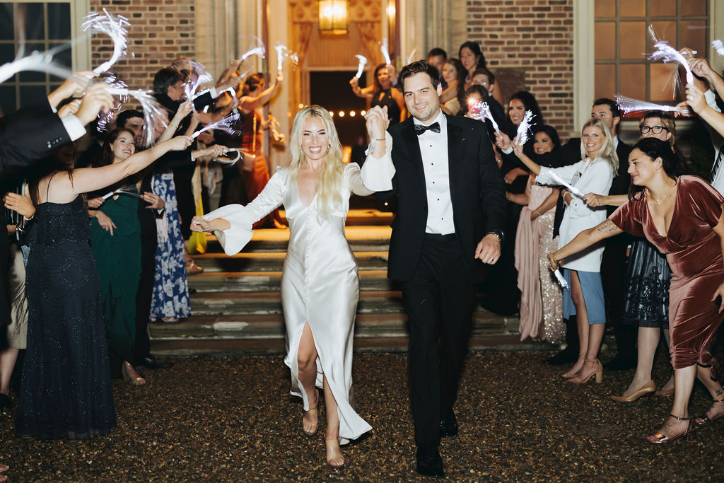 bride and groom send off with wedding guests and light shakers