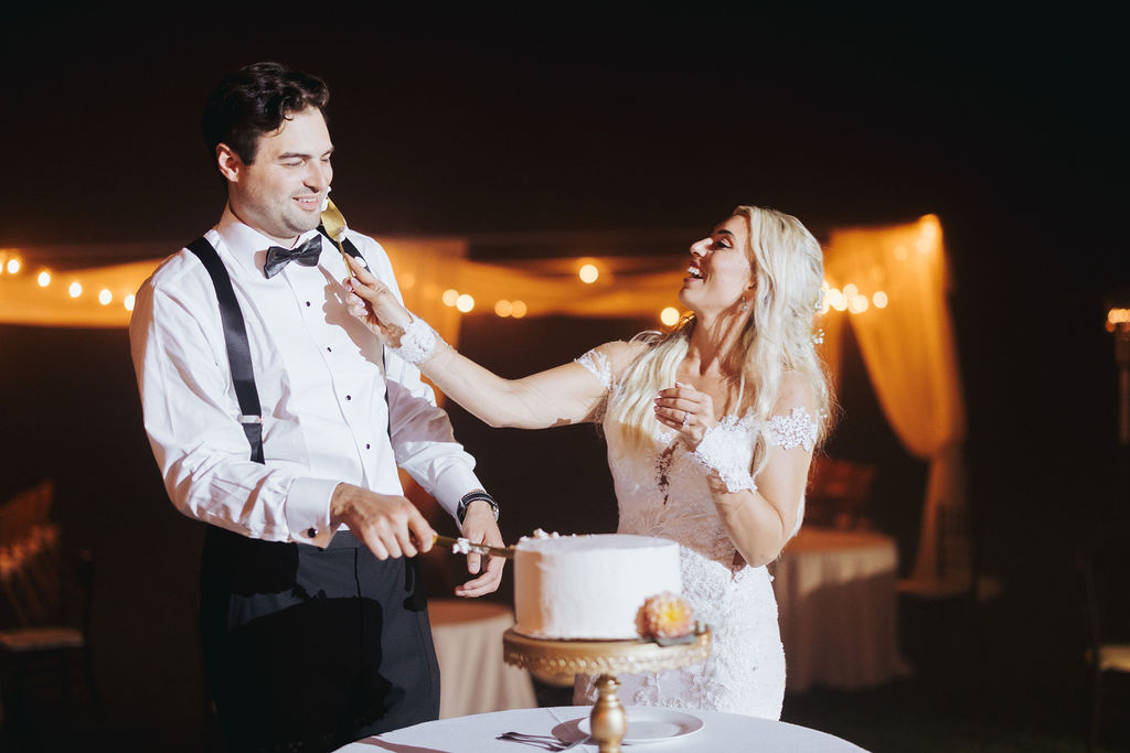 bride and groom cutting cake at crane estate reception