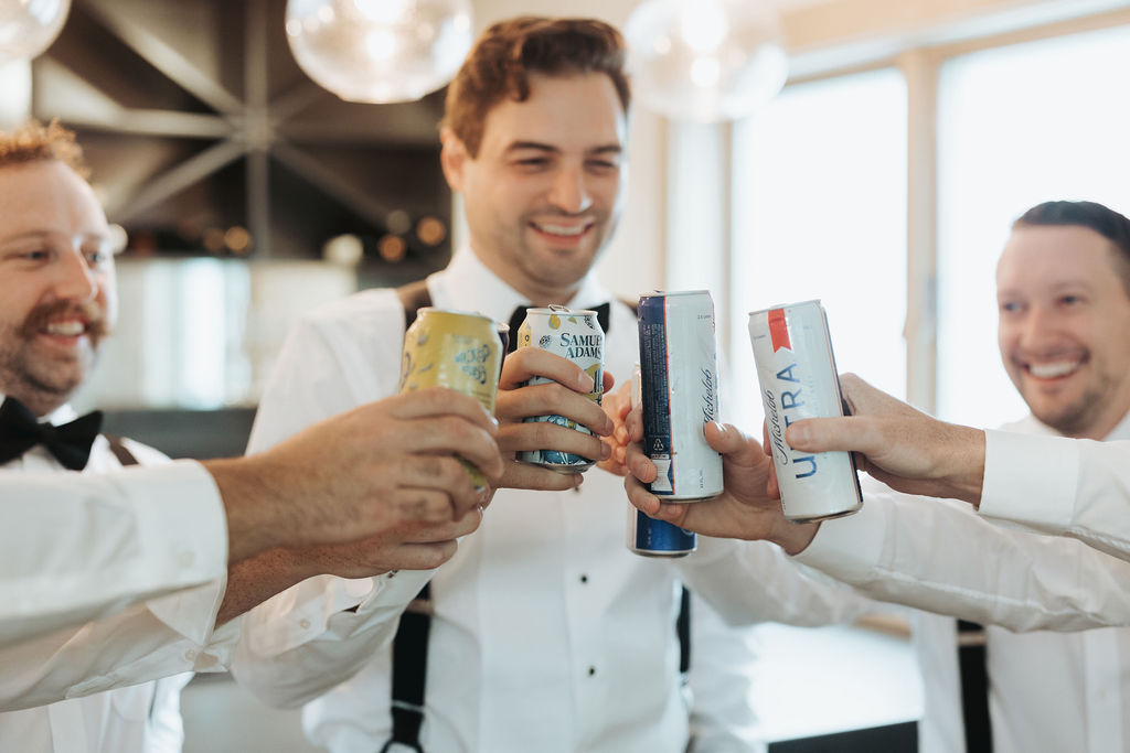 groom drinking beer with groomsmen before wedding