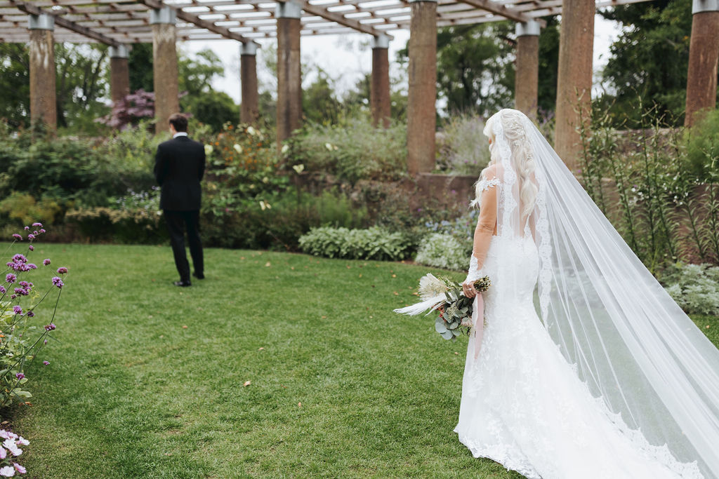 bride and groom first look in crane estate garden