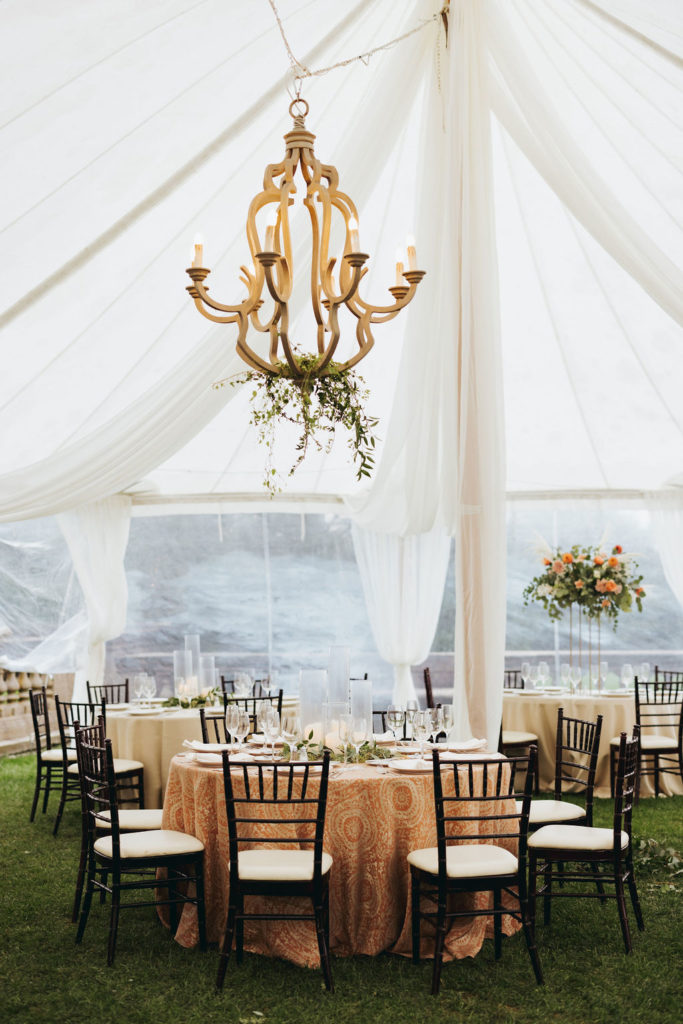 crane estate wedding reception in a tent with chandelier