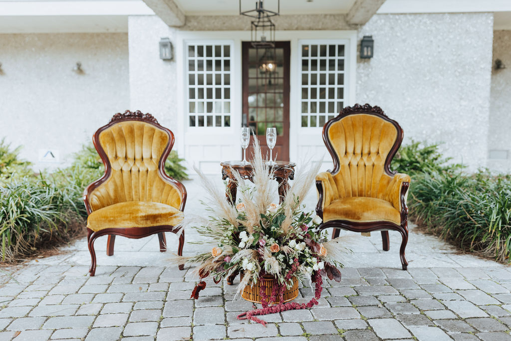 antique chairs and florals in boho wedding reception