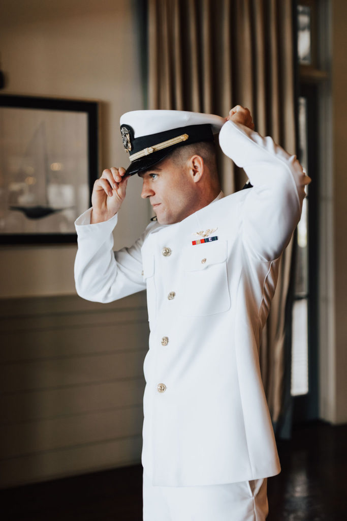 groom adjusting military hat