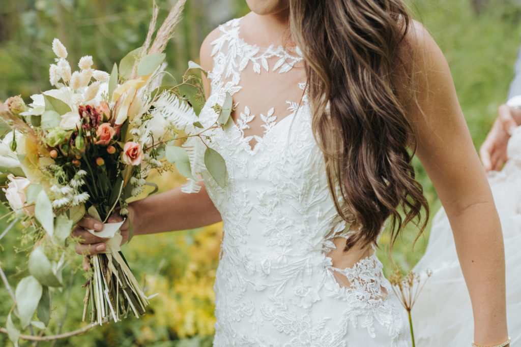 bride in open back mesh and lace dress in maroon bells colorado