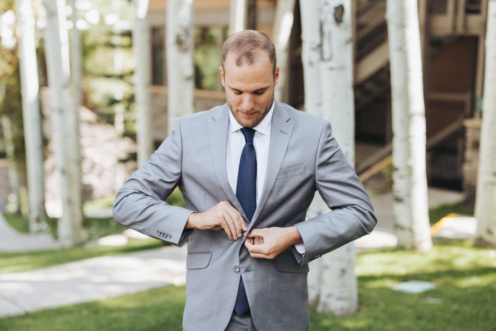 groom in gray suit and navy tie