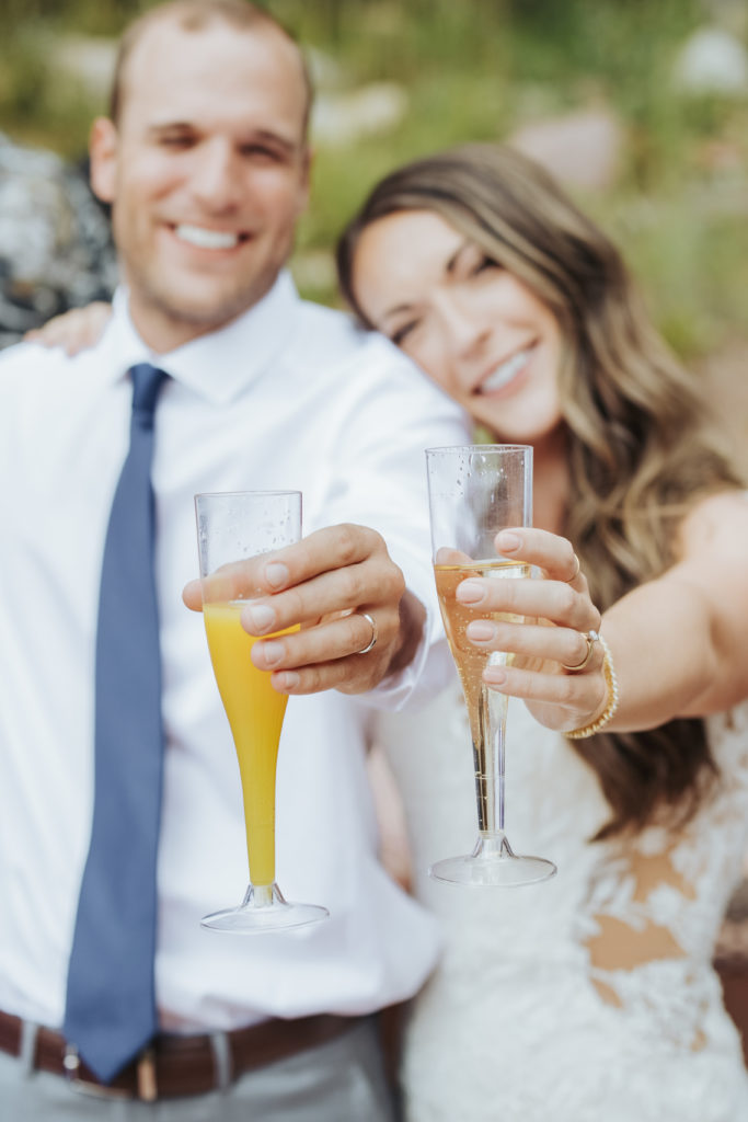 bride and groom drinking champagne at maroon bells wedding