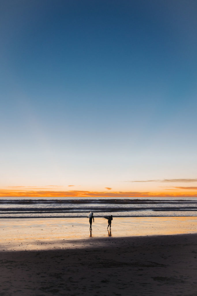 bride and groom on the beach at sunset in los angeles
