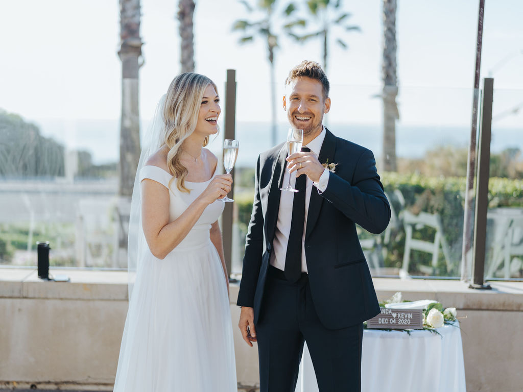bride and groom drinking champagne at southern california wedding reception