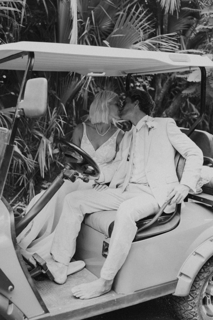 bride and groom on golf cart in costa rica