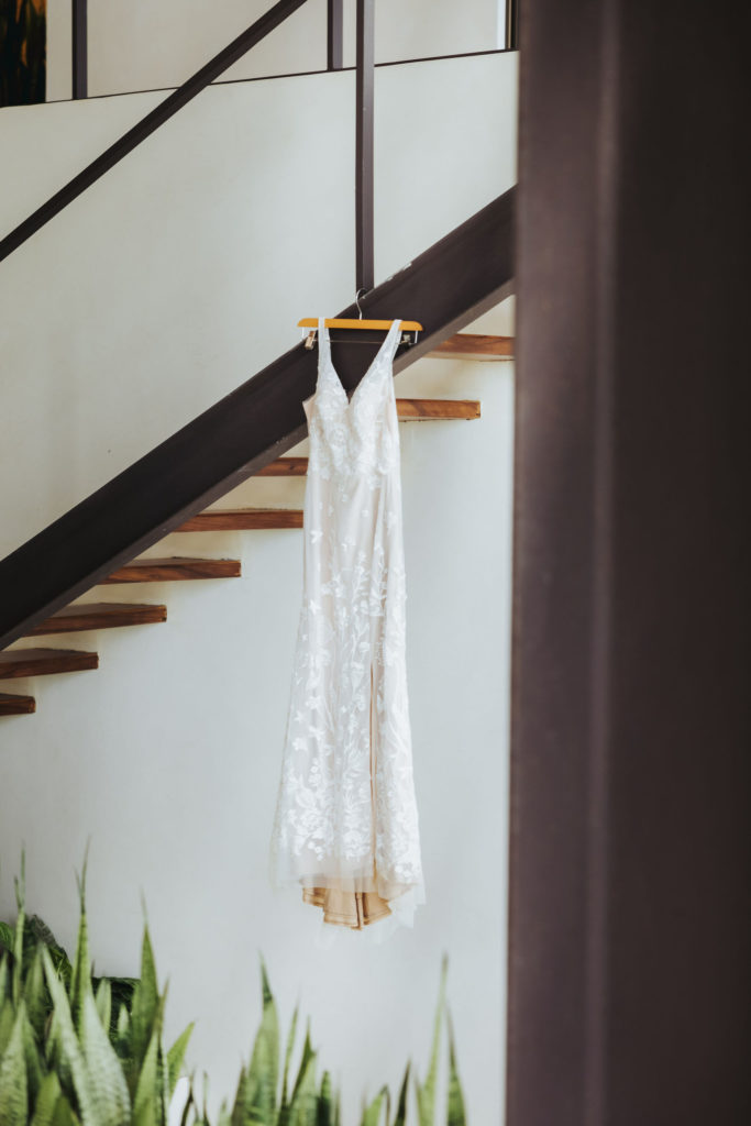 wedding dress hanging from stair case