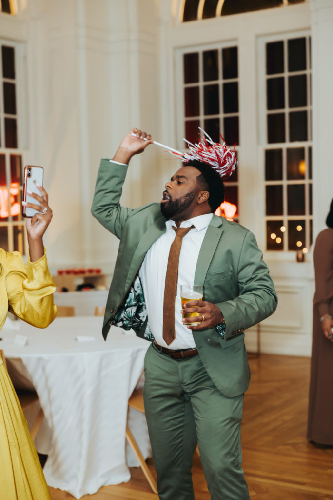 groom holding alabama shaker at wedding reception