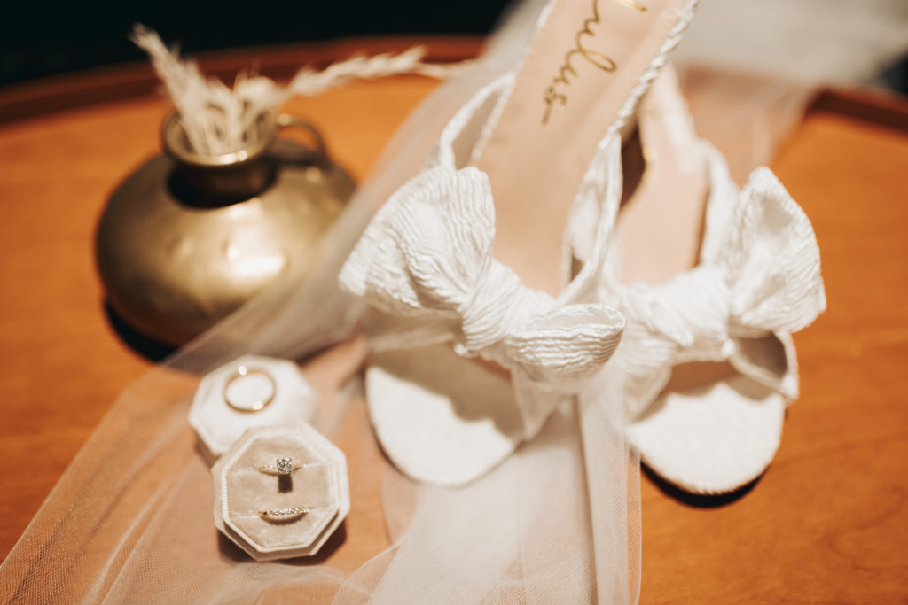 wedding shoes and rings in velvet ring box