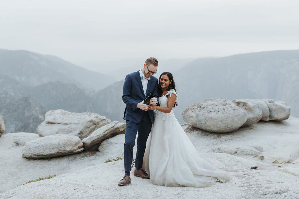 bride and groom in yosemite elopement portraits popping champagne
