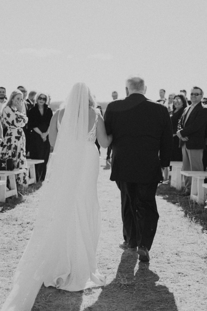 bride walking with father in utah wedding ceremony