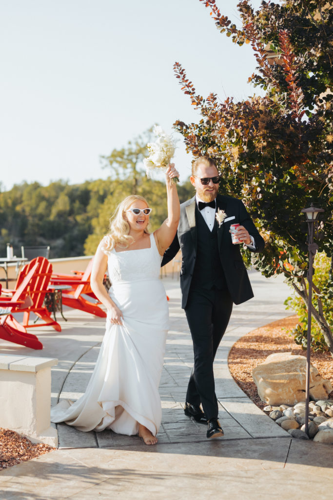 bride and groom wearing sunglasses as the enter wedding reception