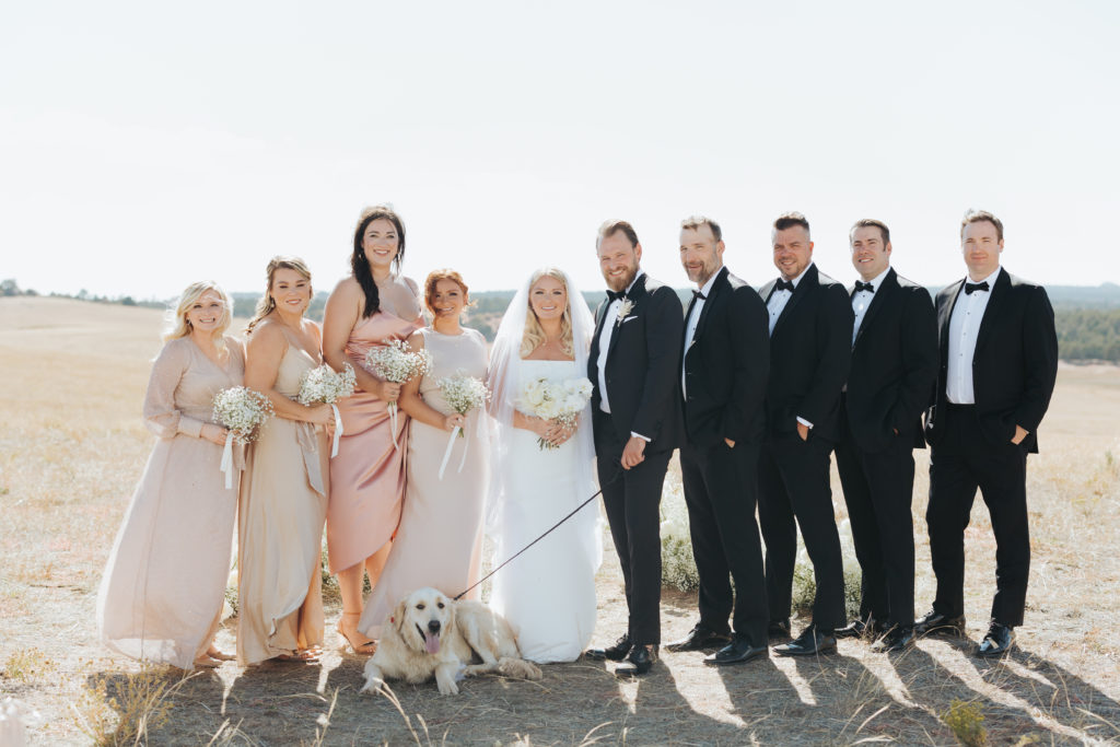bride and groom with wedding party and dog