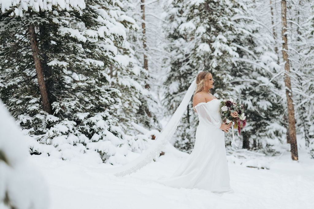bride walking in snowy trees