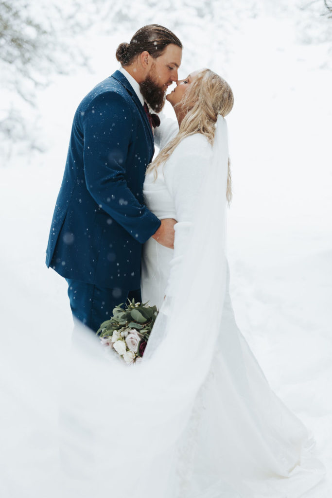 bride and groom elopement portrait in the snow