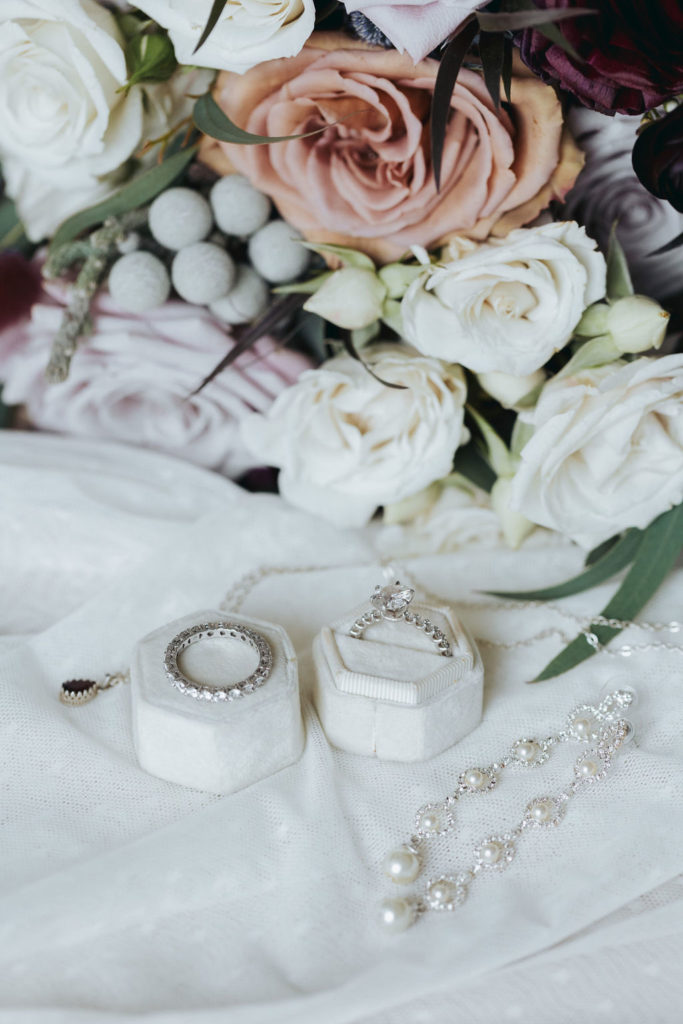 wedding rings and wedding jewelry with pink and white flowers