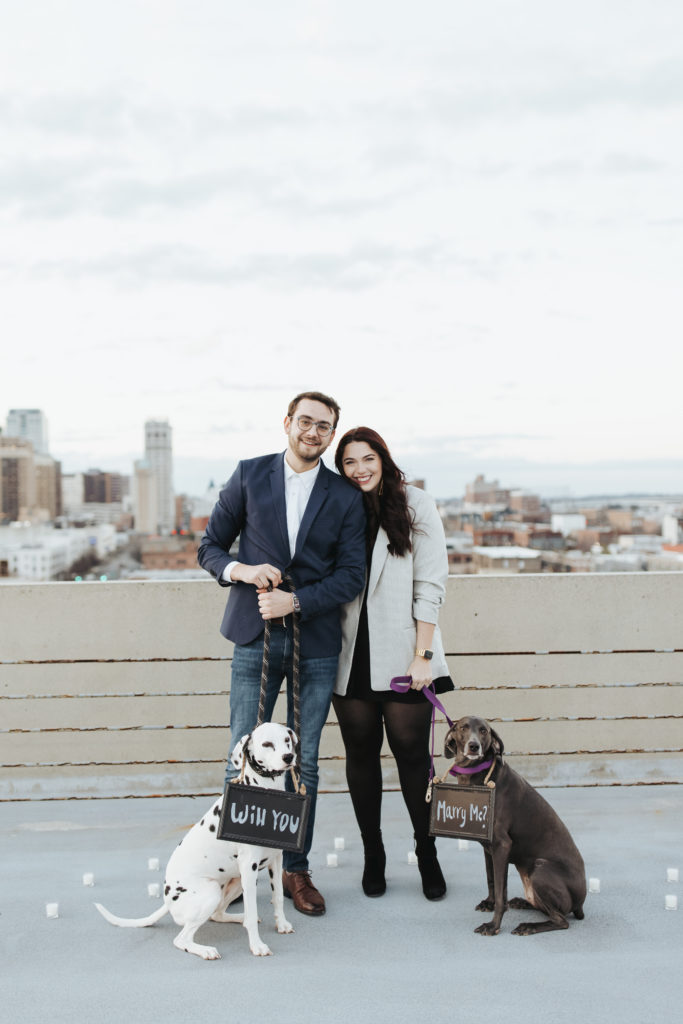 engaged couple with two dogs at birmingham rooftop proposal