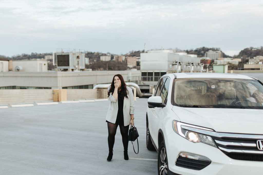 woman standing beside car at rooftop surprise proposal