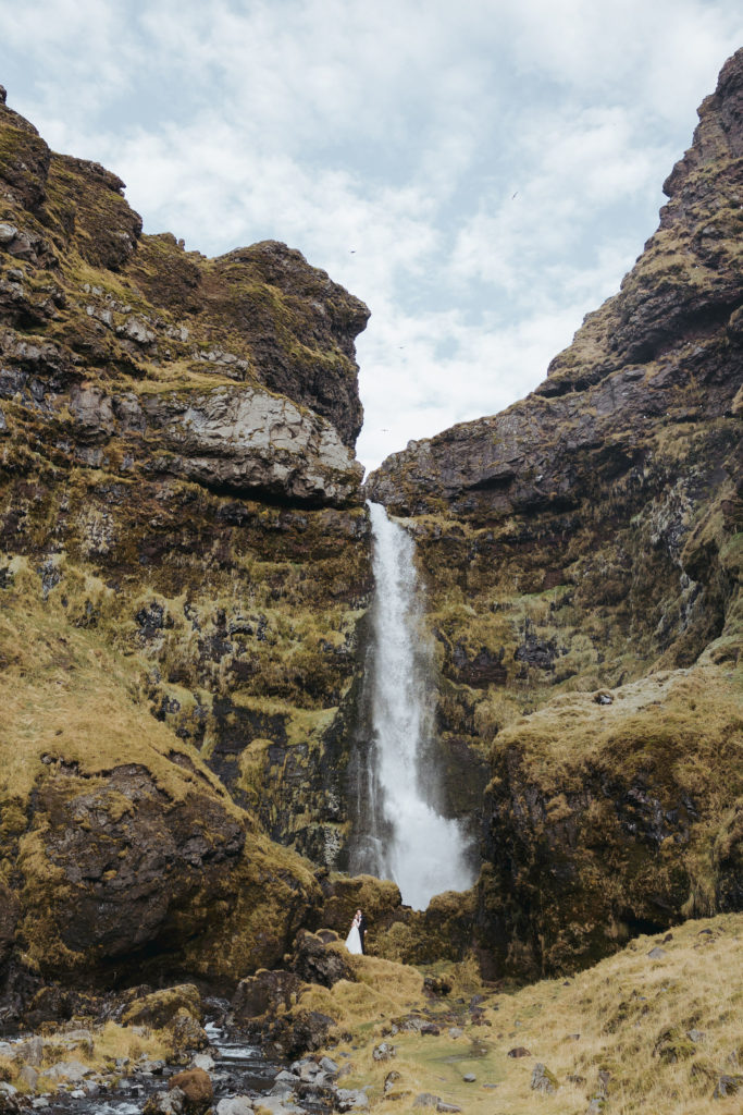 bride and groom iceland elopement ceremony with waterfall and mountains