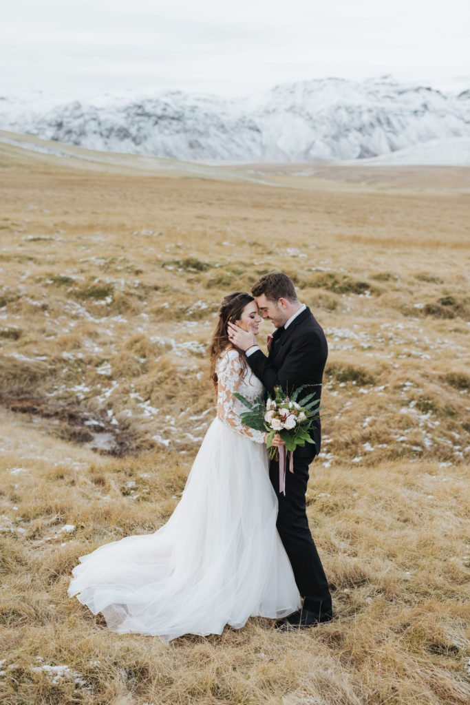 bride and groom elopement portraits on snowy mountains in iceland