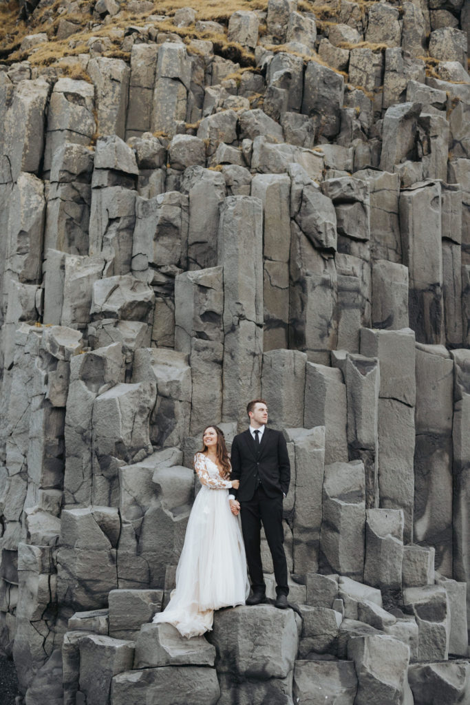 bride and groom on Reynisfjara Iceland rocks