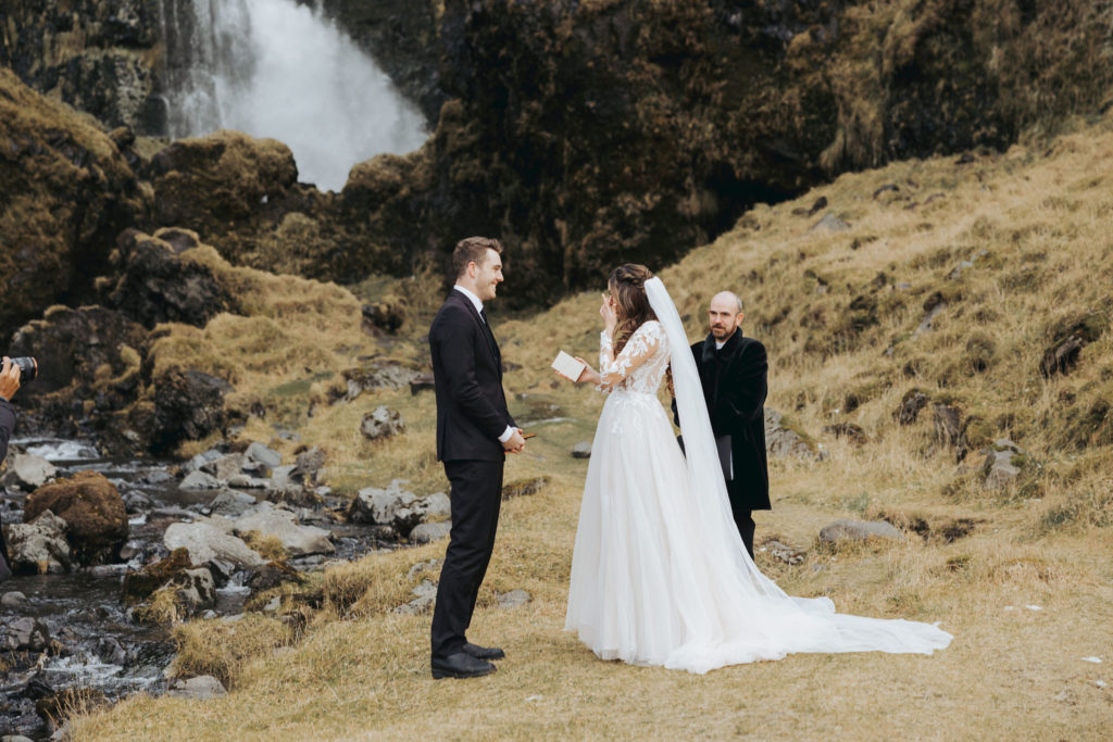 Iceland elopement ceremony with waterfall and mountains