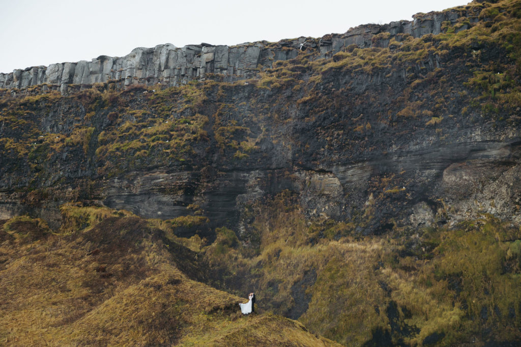 bride and groom on mountains in iceland