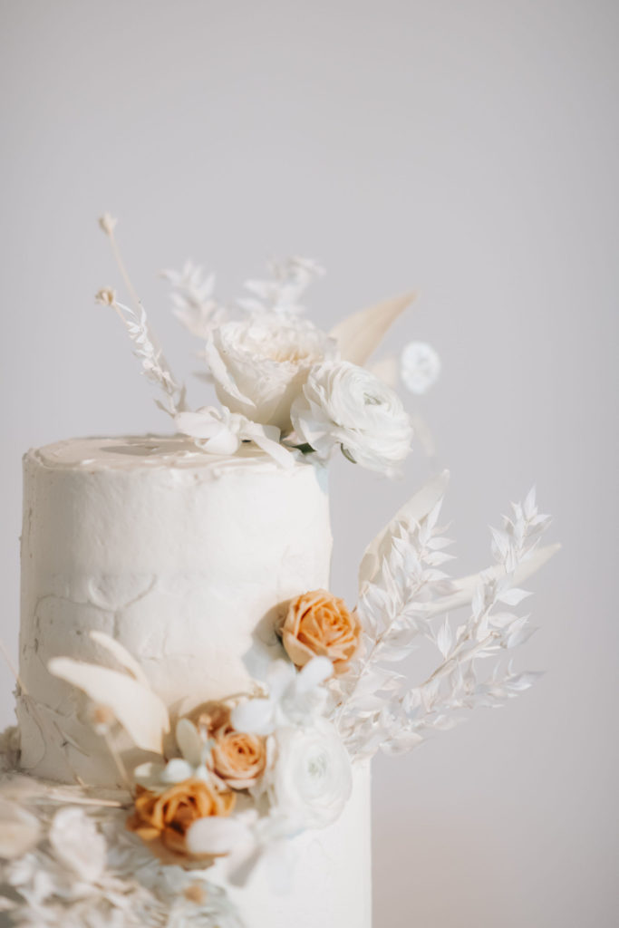wedding cake with white and blush flowers