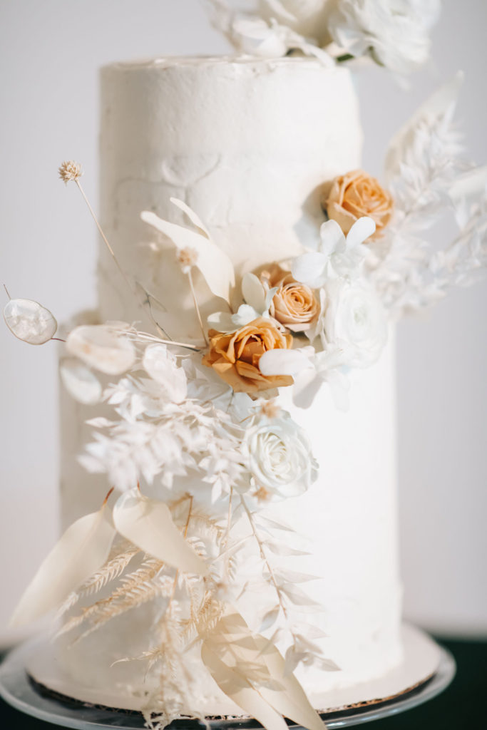 wedding cake with white and blush flowers