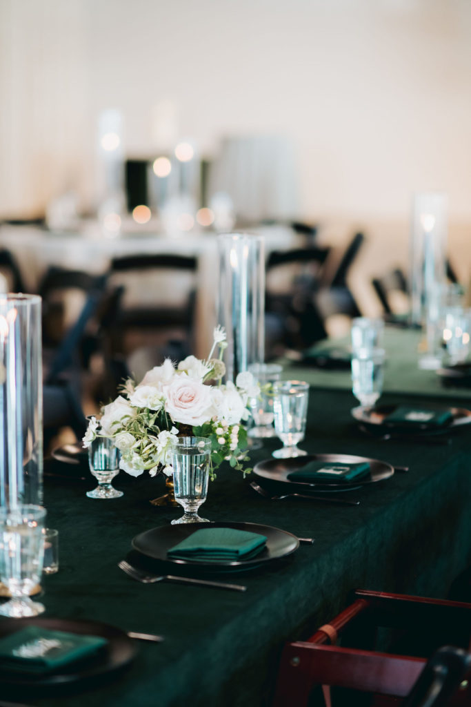 reception table decor on velvet green table cloth