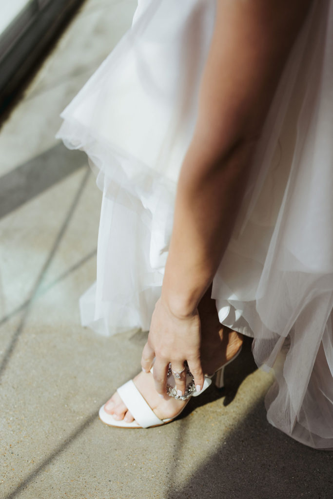 bride putting on manolo heels before wedding